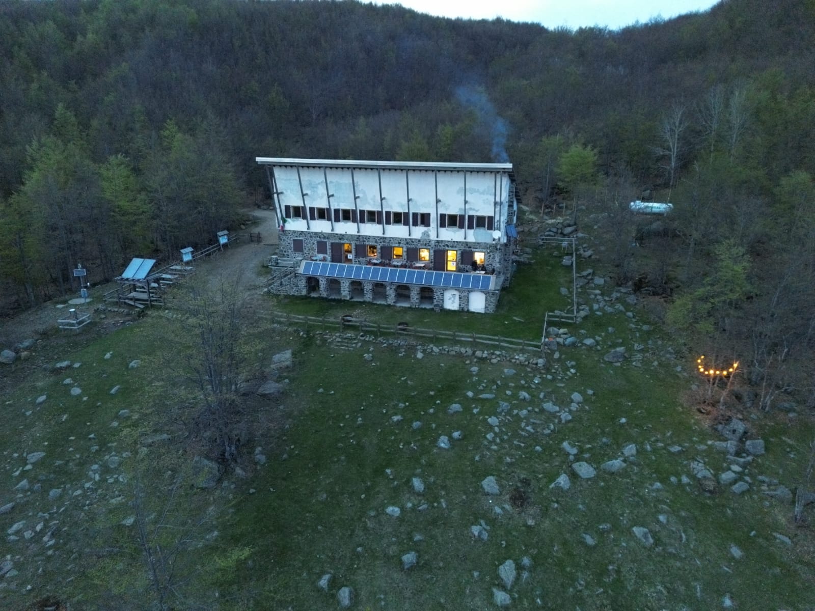 An photo of the rifugio with its terrace in front taken by drone